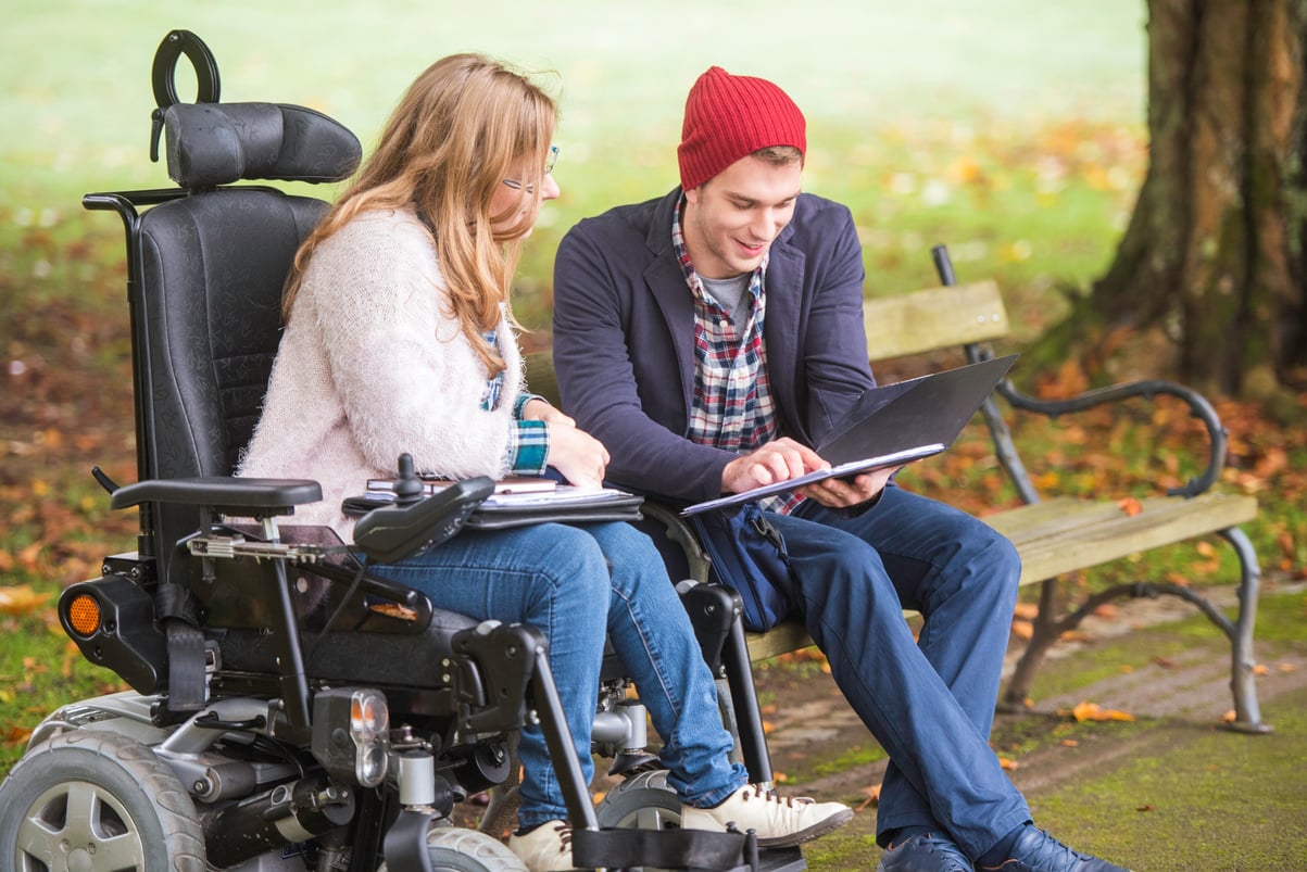 Student helping friend with disability